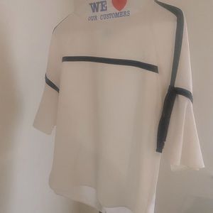 White blouse with black piping